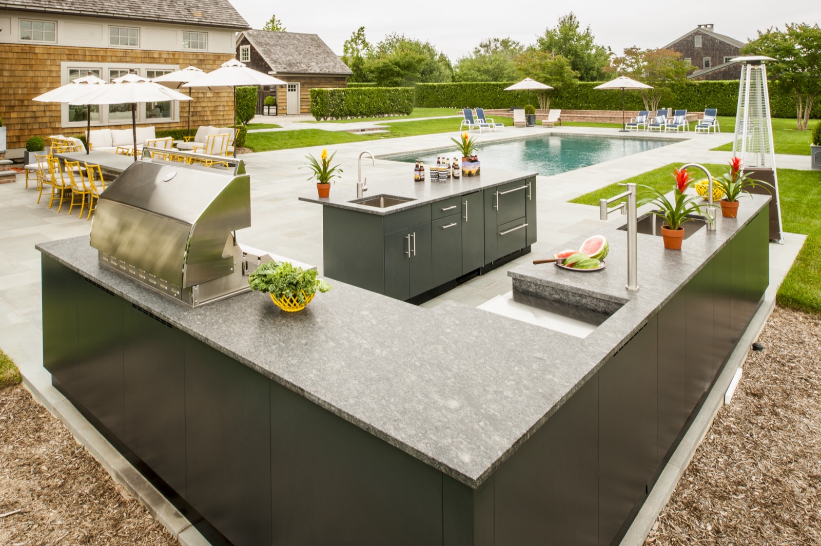 U-shaped stainless kitchen beside a pool